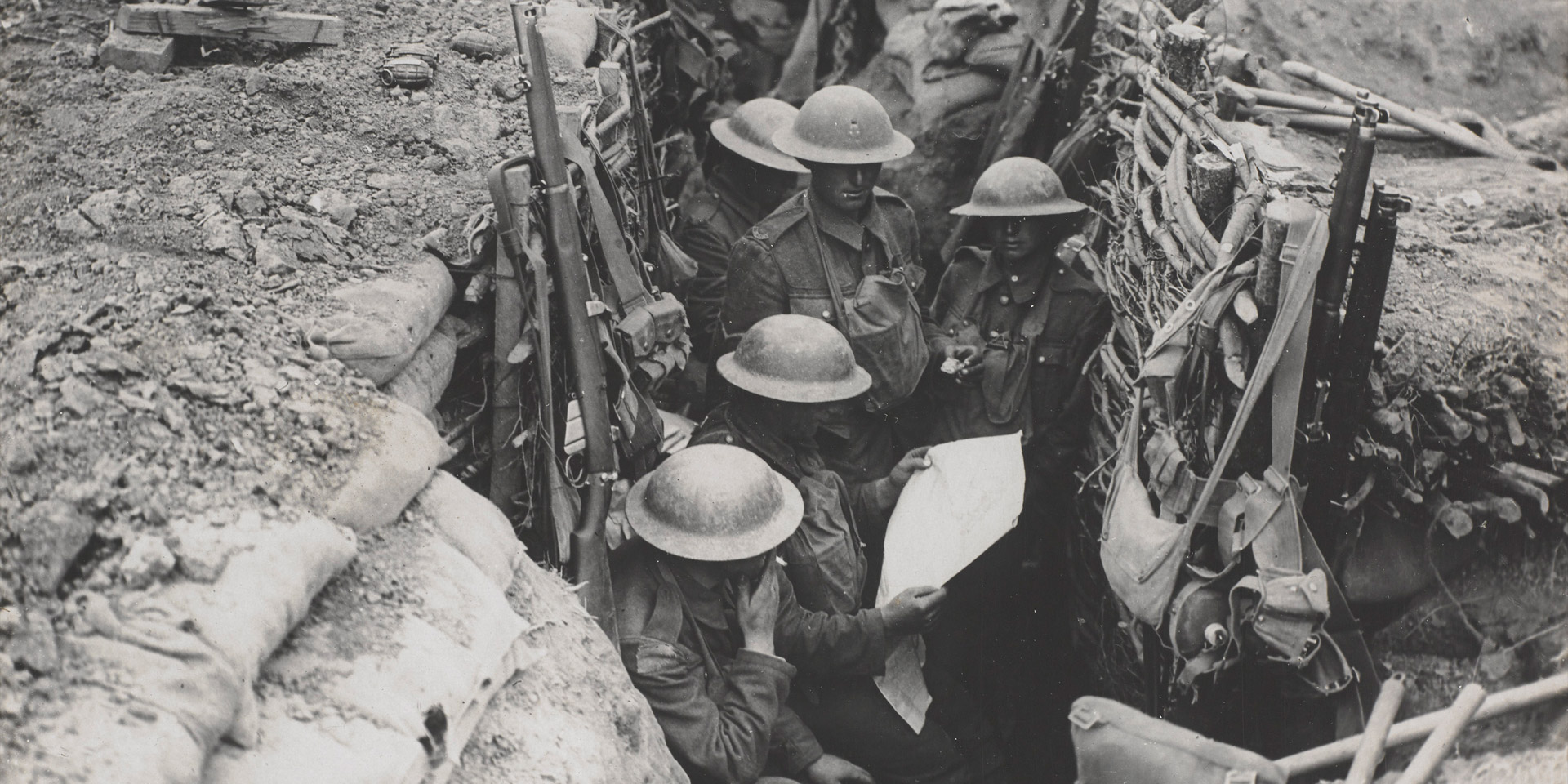 Reading a newspaper in the trenches, c1916