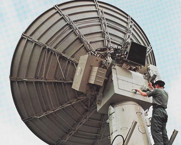 A soldier of the Royal Corps of Signals repairs a satellite dish, 1969