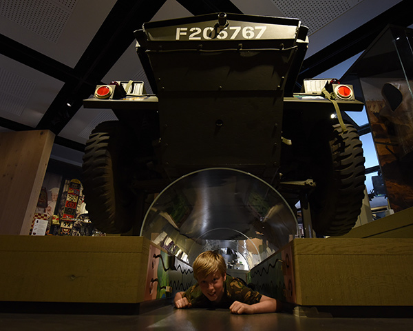 Child playing under dingo tank