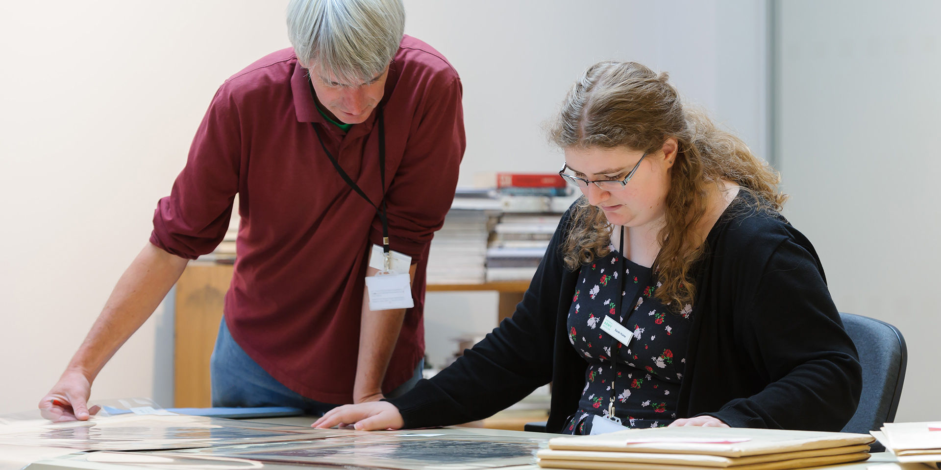 Staff  member and volunteer inspecting collection