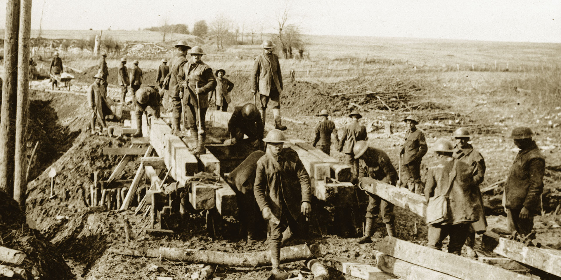 Soldiers bridging a stream in the First World War