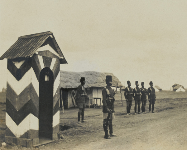 A King's African Rifleman by a sentry box, 1916