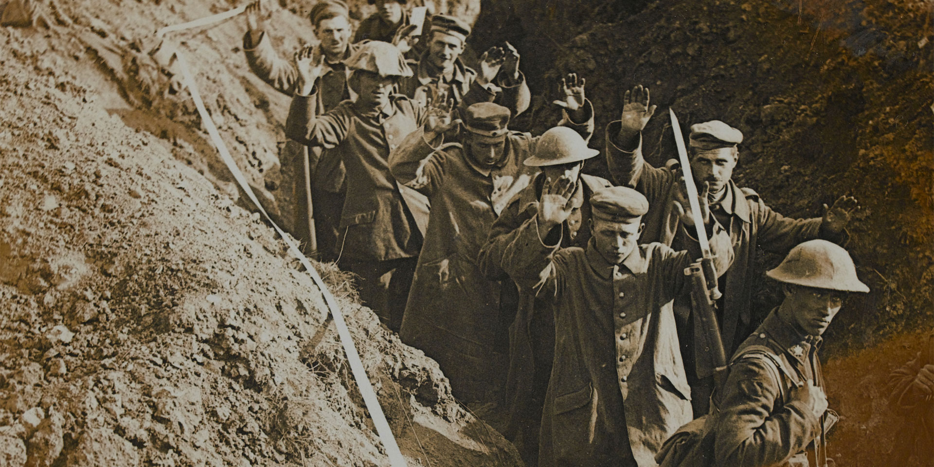 Canadian soldiers escorting German prisoners through a trench, August 1918