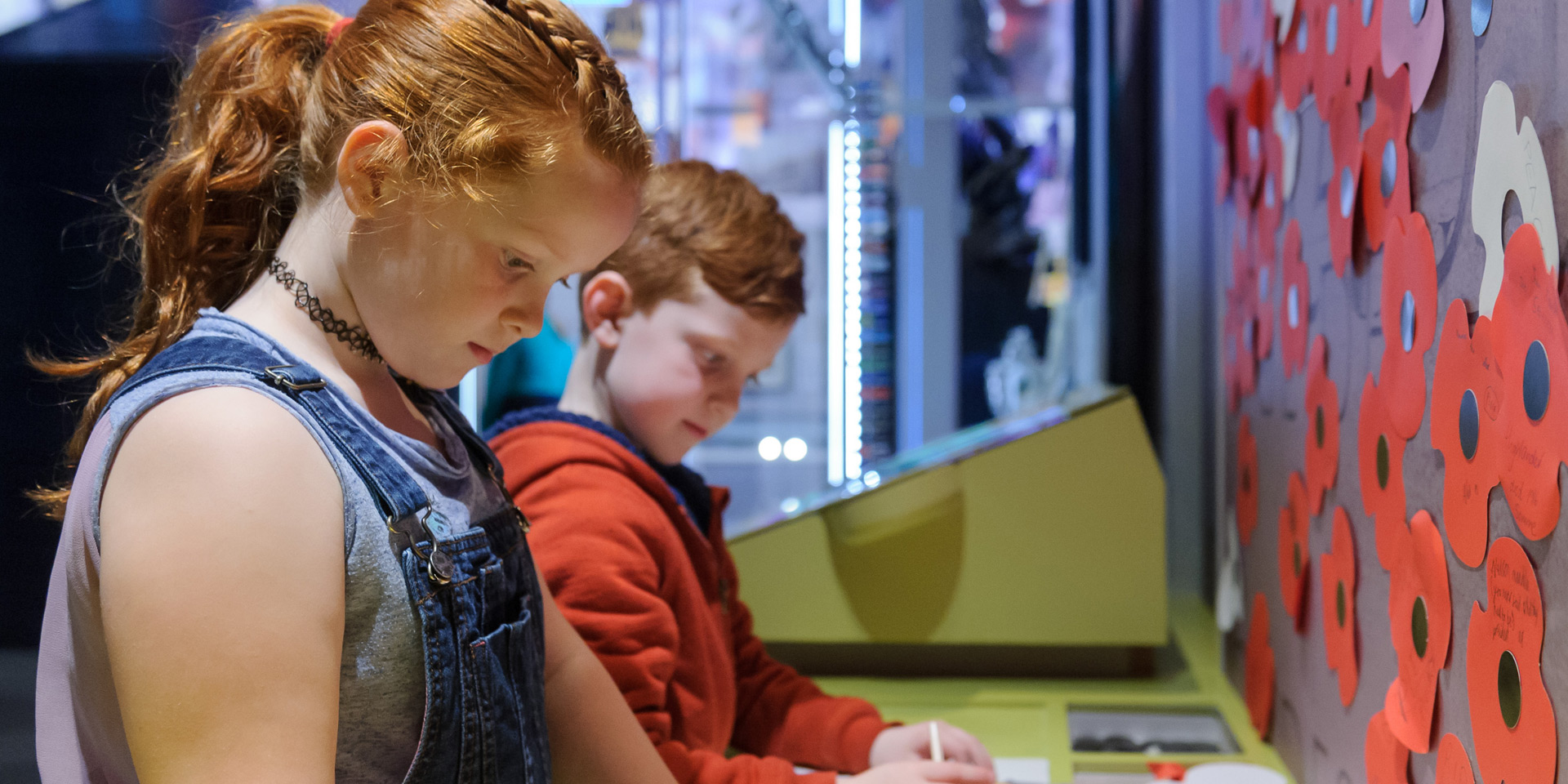 Children at the Remembrance wall in Society gallery