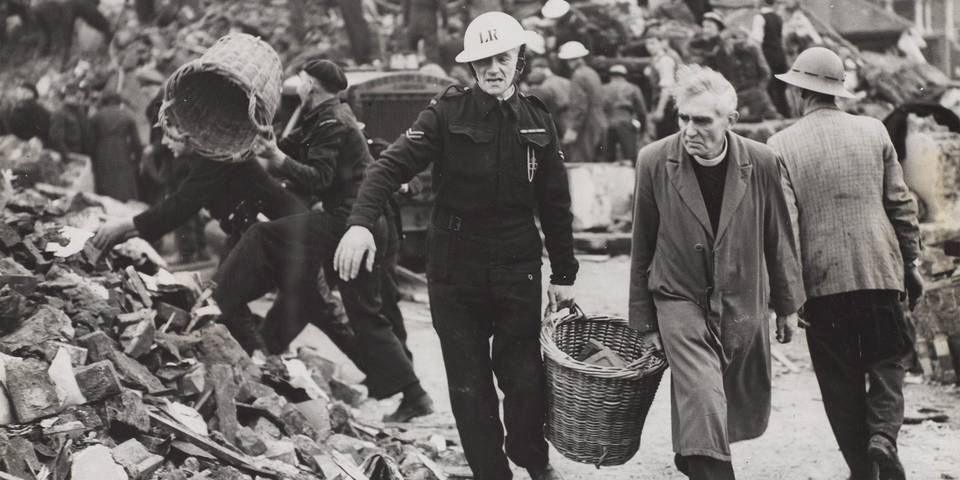 A clergyman and Civil Defence workers helping to clear the debris of a London school, 1940