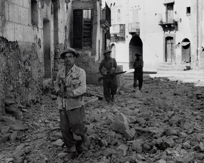Members of the 6th Queen's Own Royal West Kent Regiment on patrol in Adrano, Sicily, 1943