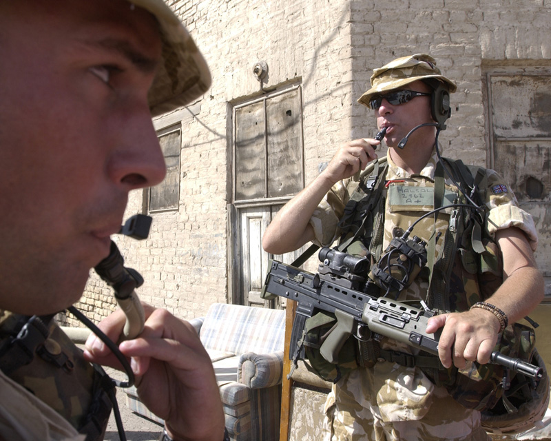 Soldiers of the Cheshire Regiment take on water during a patrol in Basra, 2004