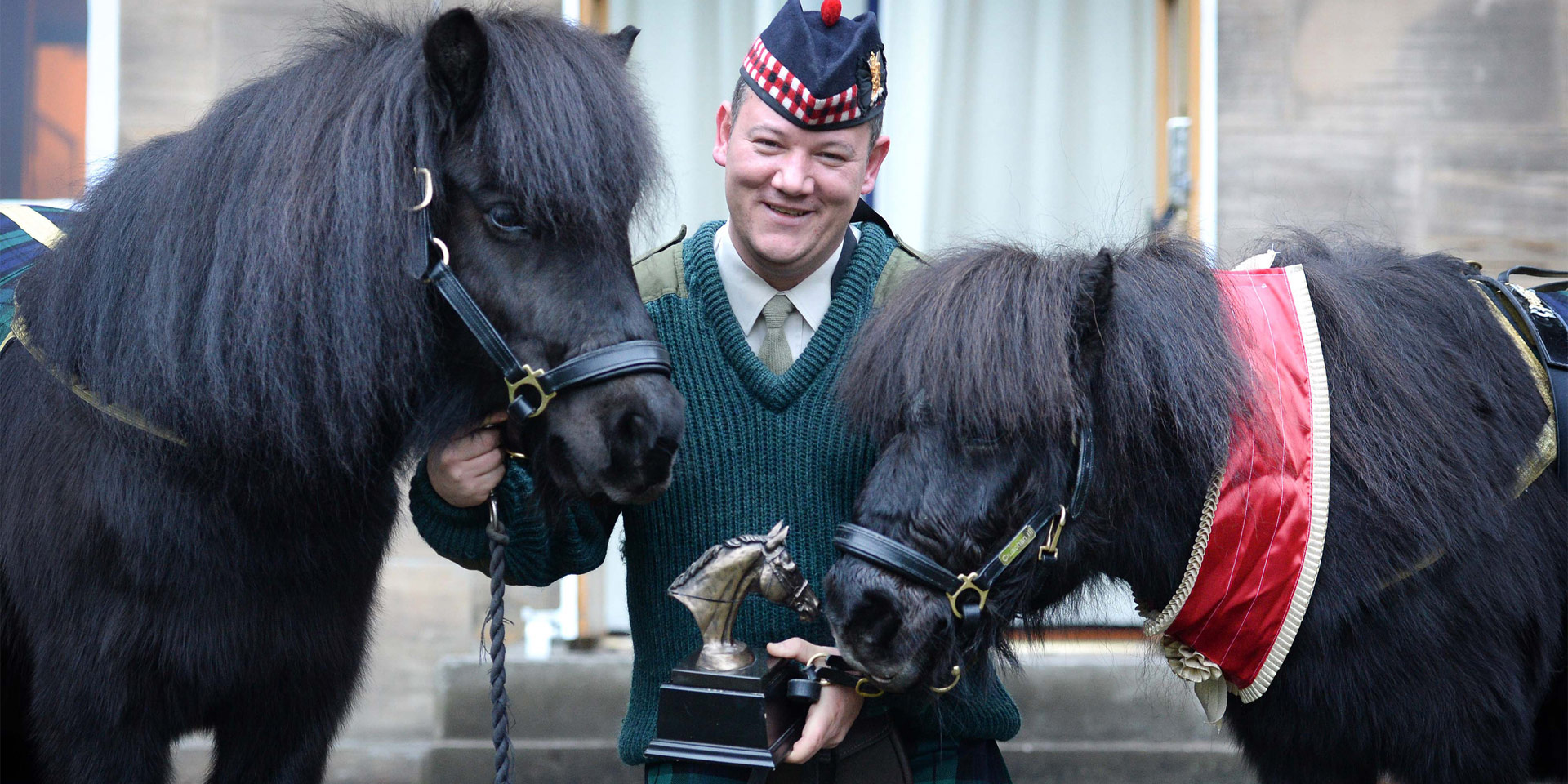 Pony Major Corporal Mark Wilkinson with Cruachan III, and Cruachan IV, his successor as regimental mascot of the Royal Regiment of Scotland, Edinburgh, 2015