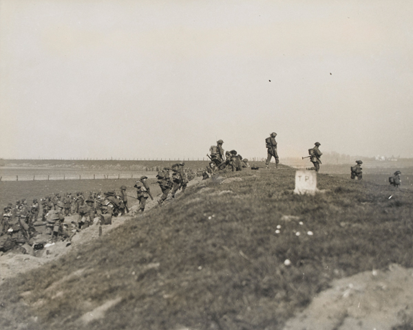 The Gordon Highlanders advance over the flood bank of the Rhine, 1945