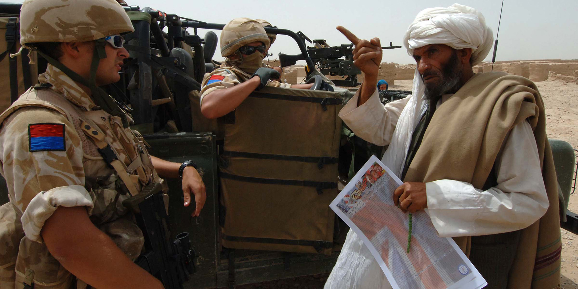 A local villager in discussion with British soldiers, Helmand, Afghanistan, 2006