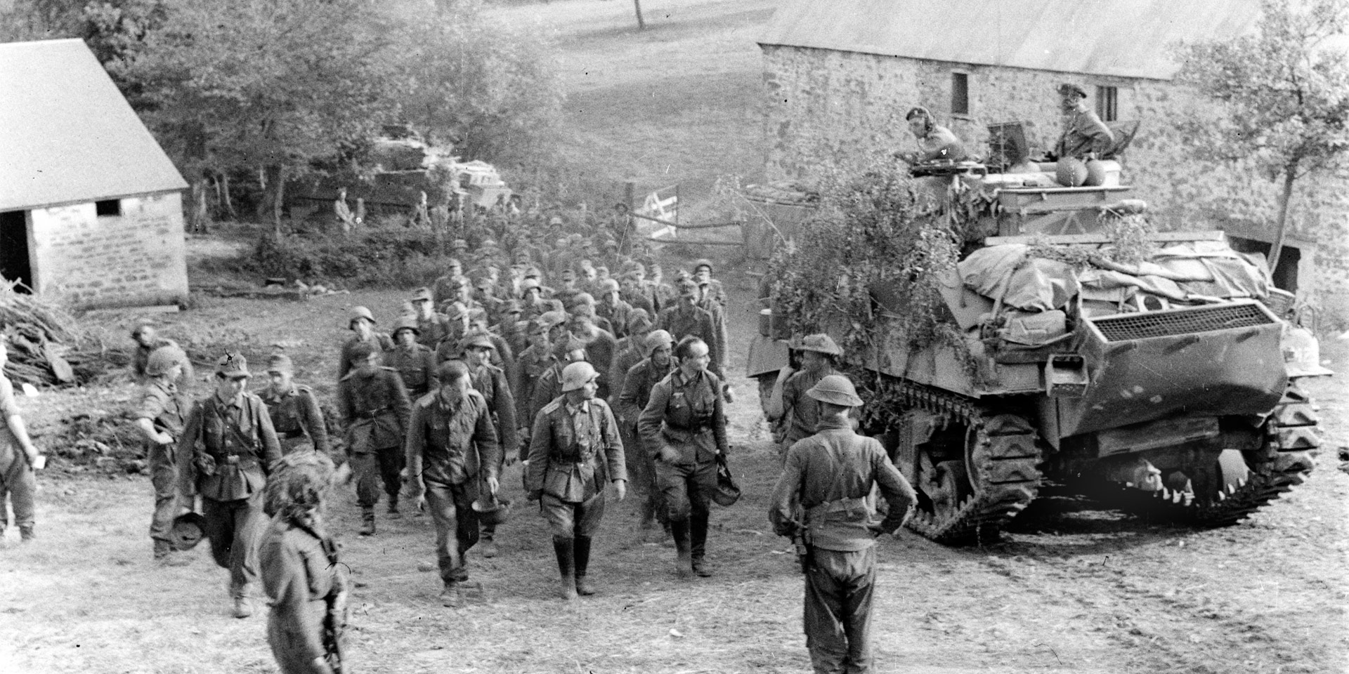 German prisoners marching past a Sherman tank, Normandy, 1944