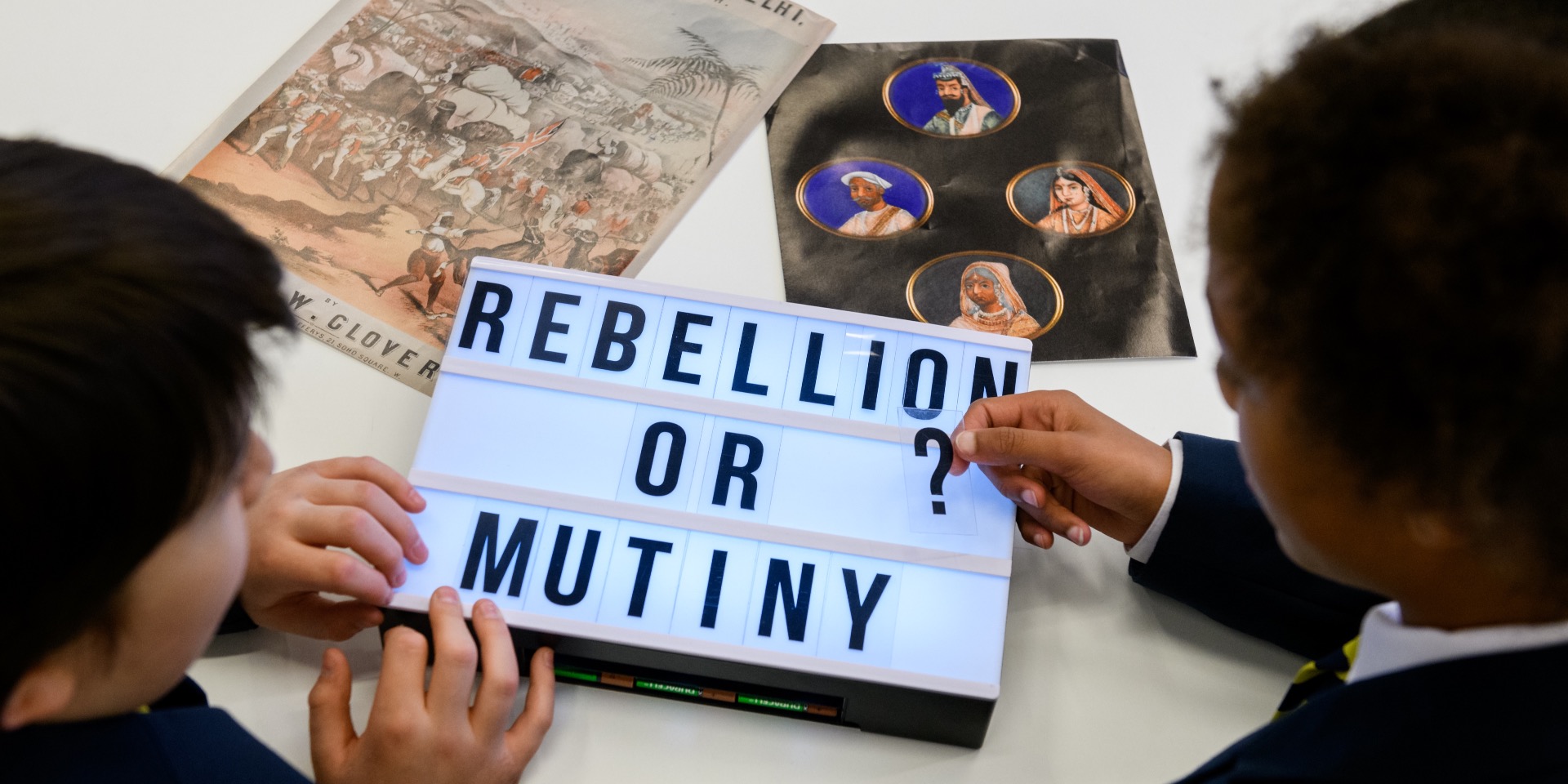 School children examining artefacts relating to the Indian Mutiny