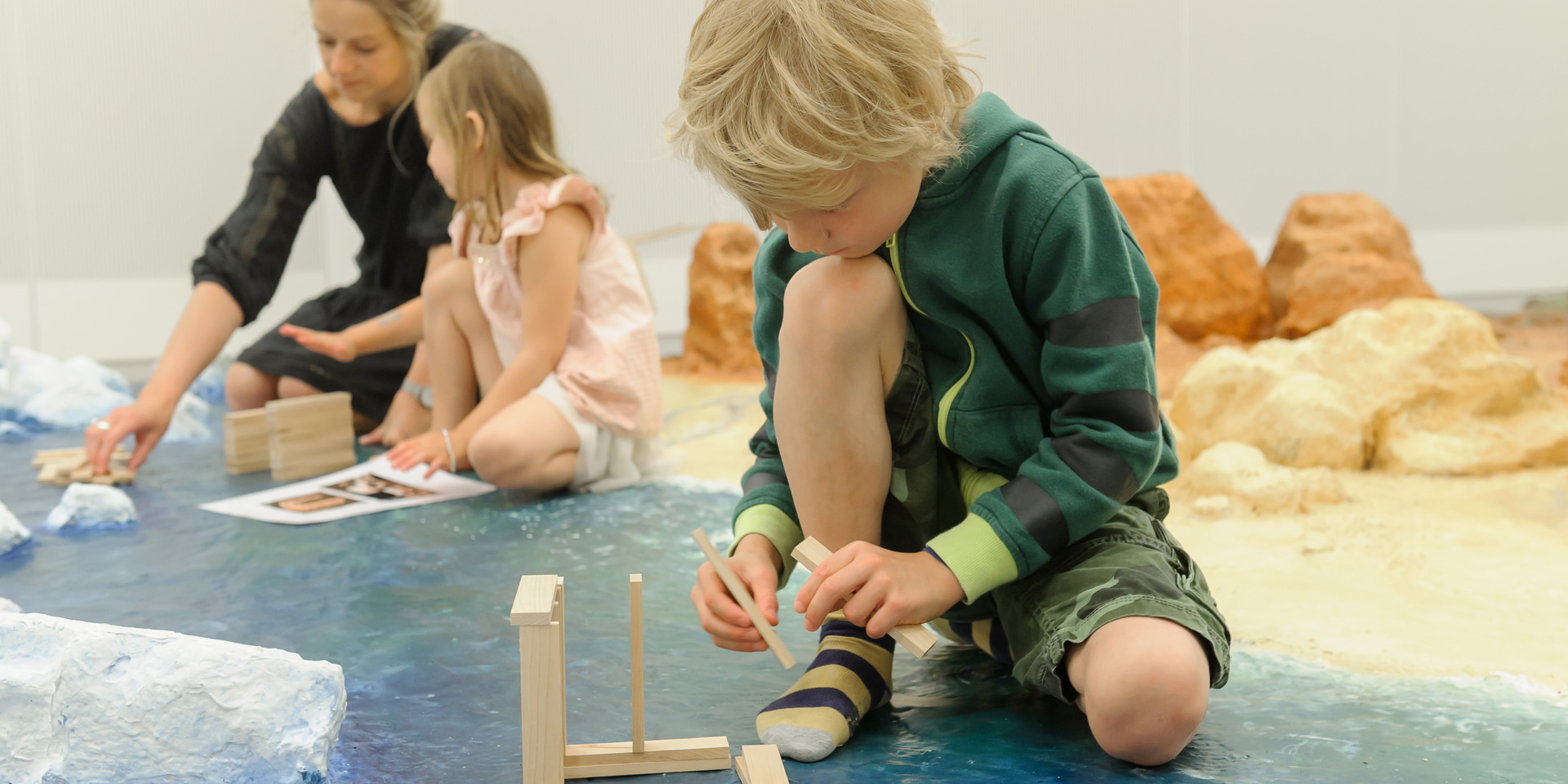 Families building wooden block structures