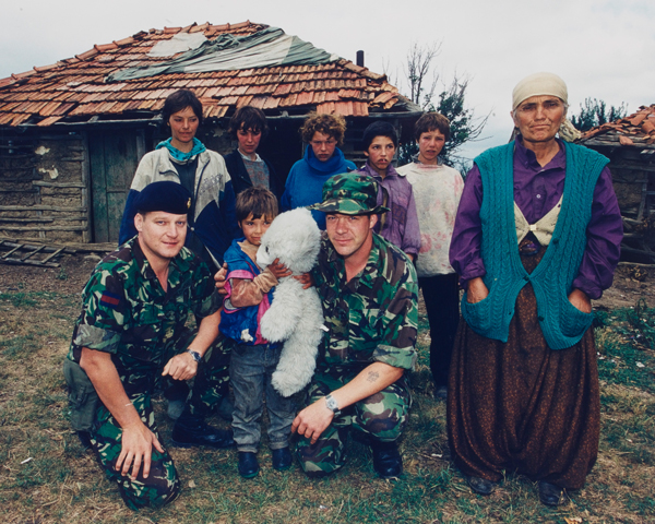 Soldiers with a refugee Kosovo Albanian family, 1999