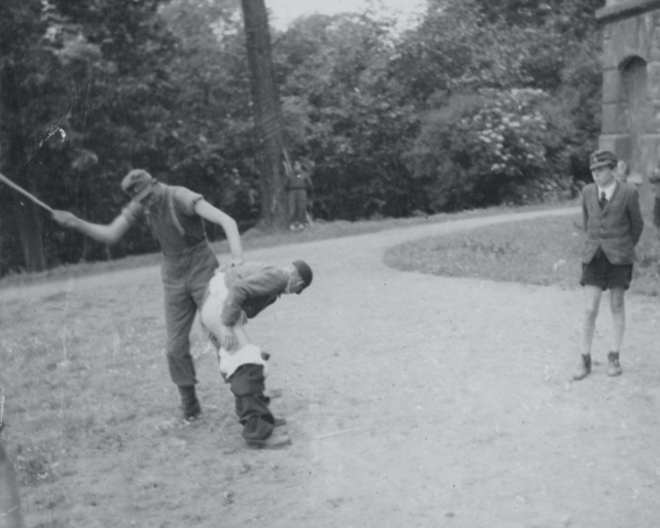 German youths being beaten for stealing from British troops, 1945