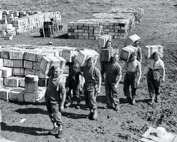 A 'compo ration' dump and men carrying supplies to it, March 1943