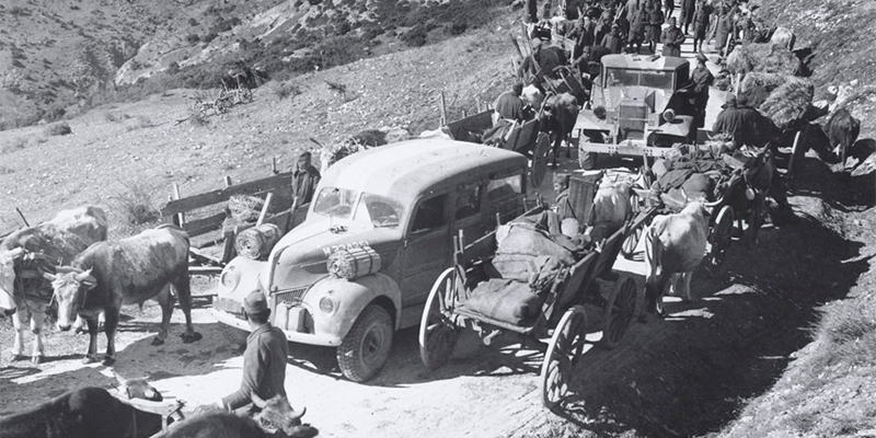 British vehicles pass through a Greek column, 1941