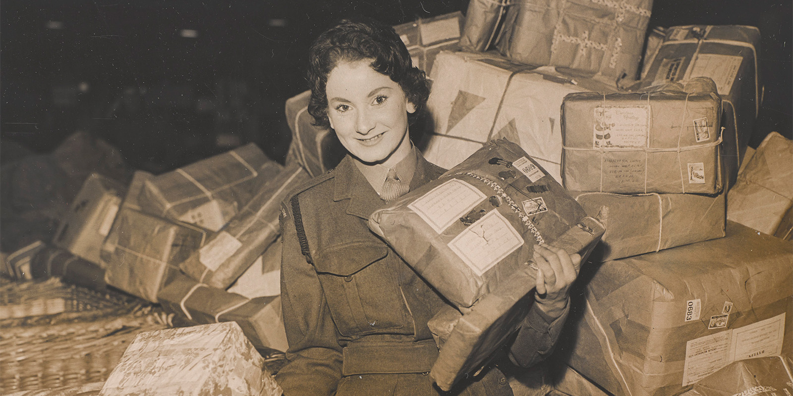 A member of the Women's Royal Army Corps carrying out postal work at Christmas time, c1950