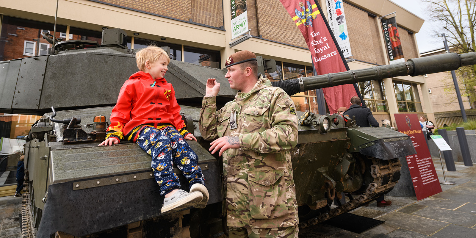 Soldier and boy with tank outside the National Army Museum