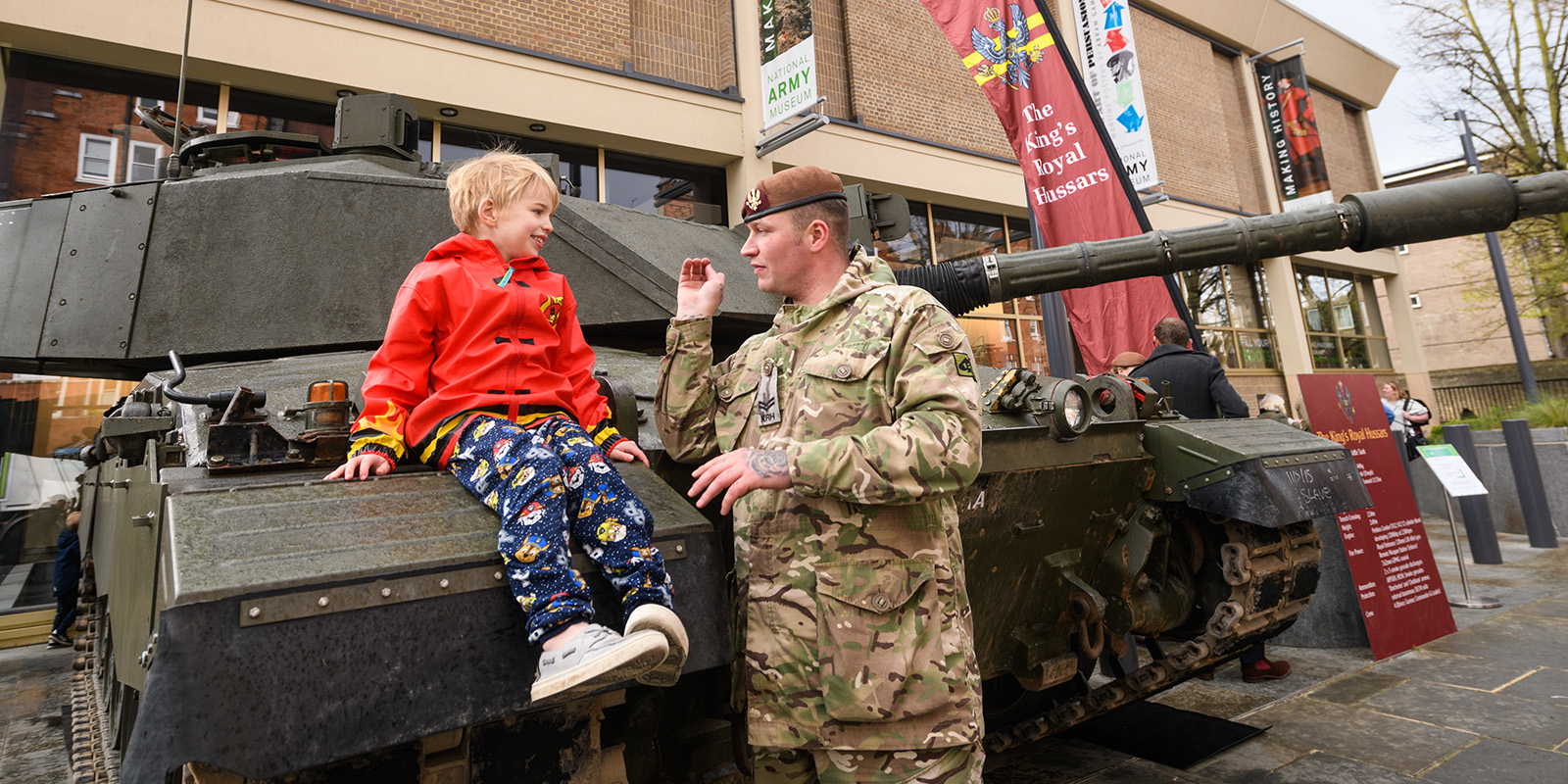 Soldier and boy with tank outside the National Army Museum