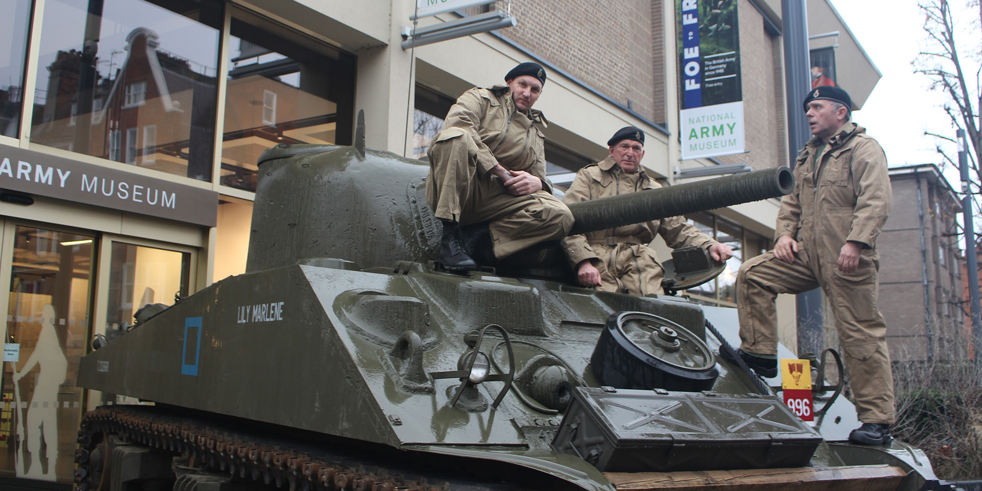 Second World War living historians on a Sherman tank outside the National Army Museum