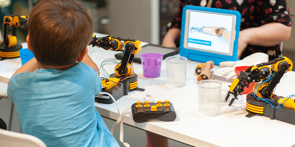 Child operating a robotic arm at the National Army Museum