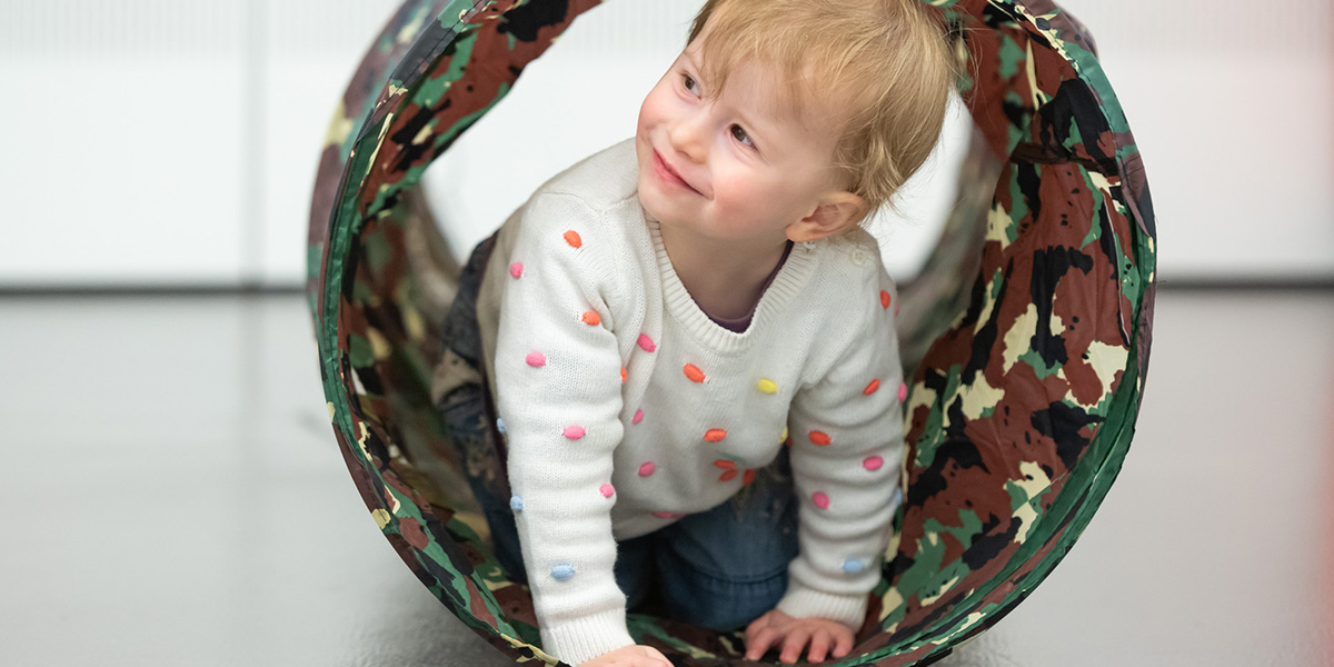 Toddler in a play tunnel at the National Army Museum