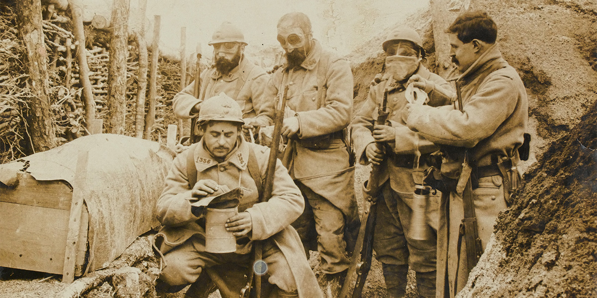 French troops don their gas masks while manning a trench, c1915