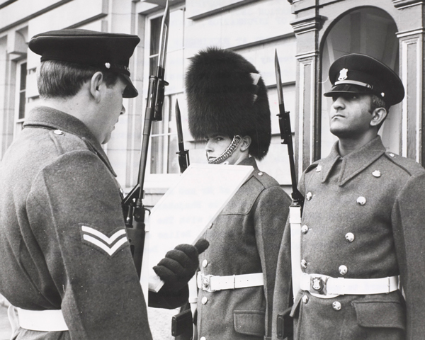 Lance Corporal Hassam Judoo, The Devonshire and Dorset Regiment (right) relieving Welsh Guardsman, Buckingham Palace, 1975