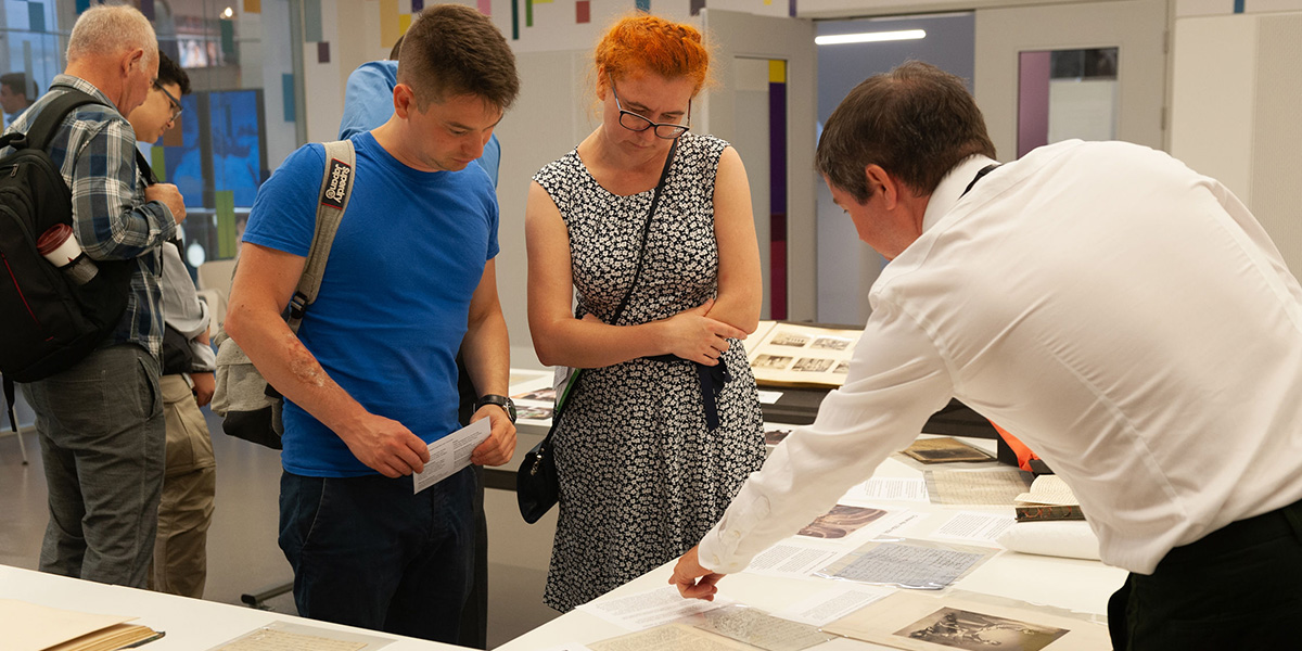 Visitors take a closer look at a selection of archival material