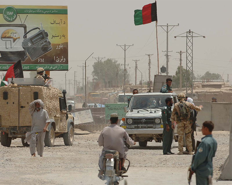 A member of the Royal Military Police (right of picture) discusses security issues with the Afghan National Police, Afghanistan, 2006