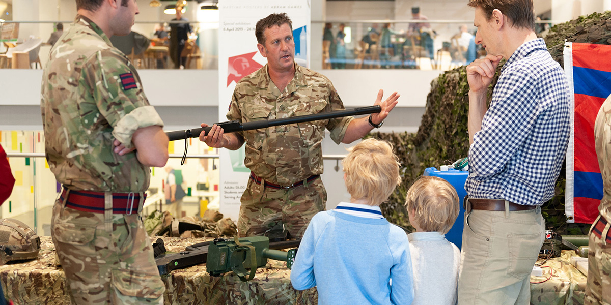A family talking to a soldier at a National Army Museum spotlight event