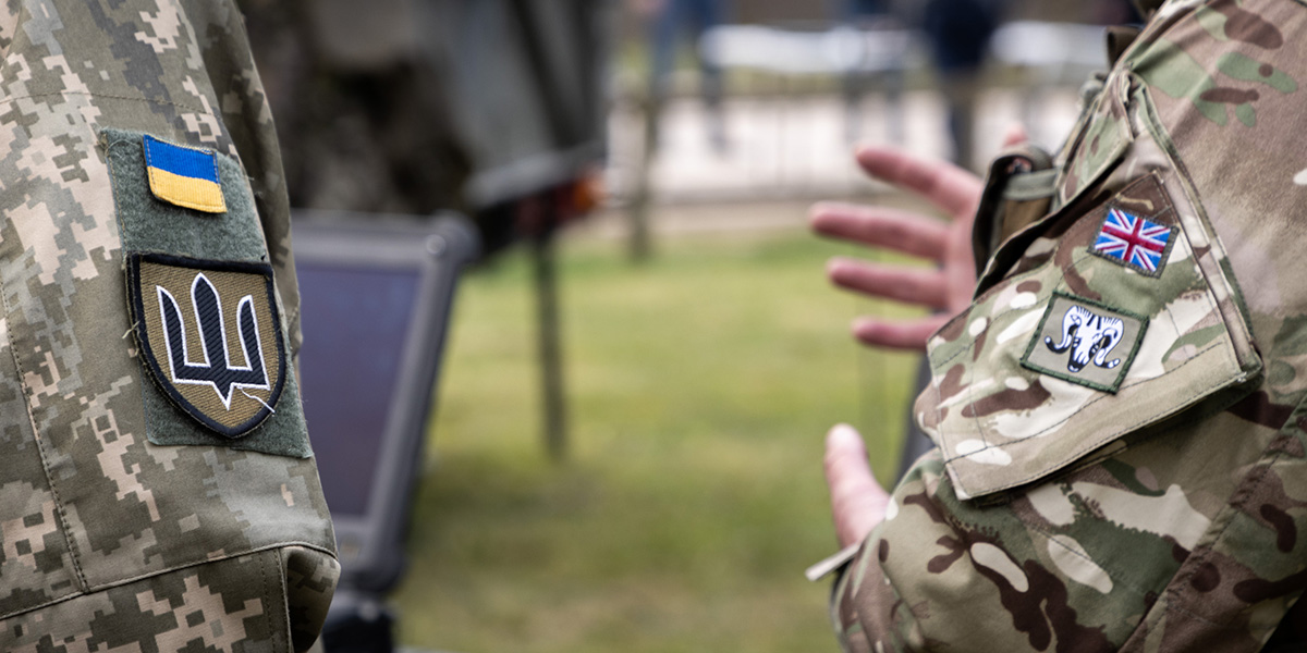 A Ukrainian soldier stands with a British soldier during a capability demonstration, Salisbury Plain Training Area, 2022