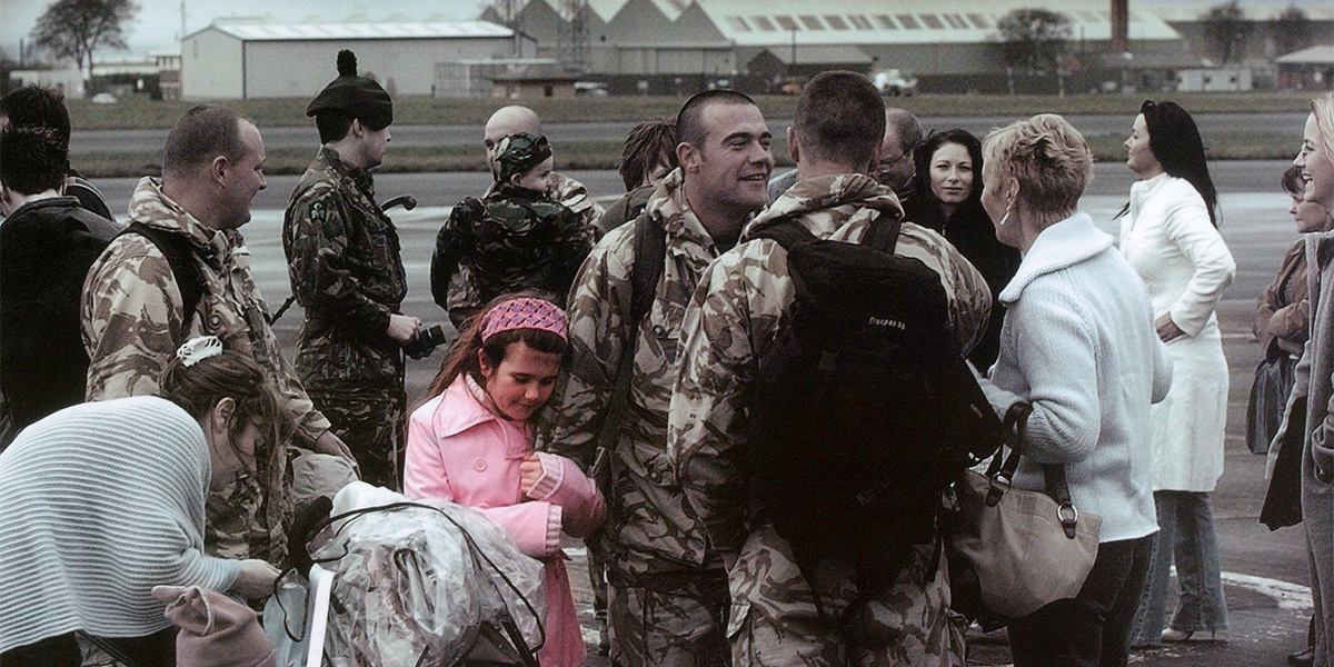Soldiers saying goodbye to their families on an airfield