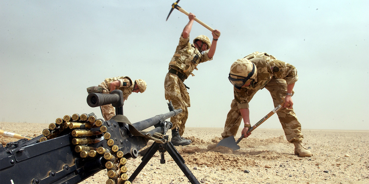 Digging fox holes, Iraq, March 2003