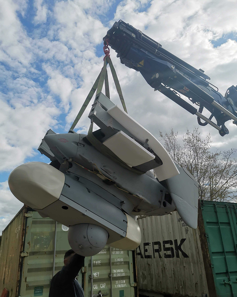 The Phoenix UAV (minus wings) being lifted onto a transportation truck by crane