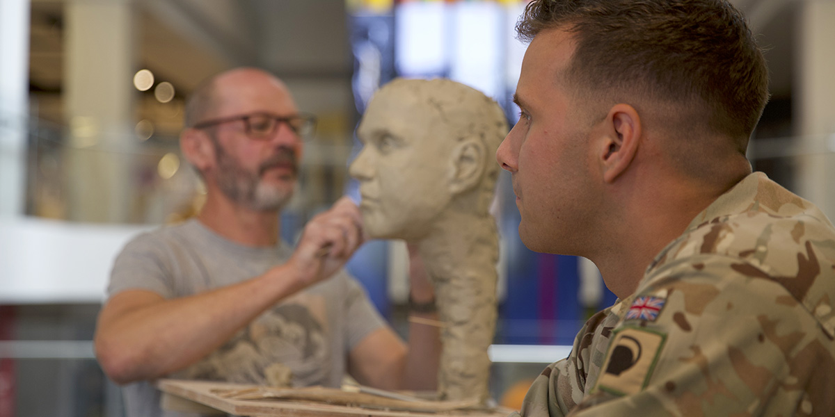 Ian Wolter at work on a portrait project sculpting a soldier