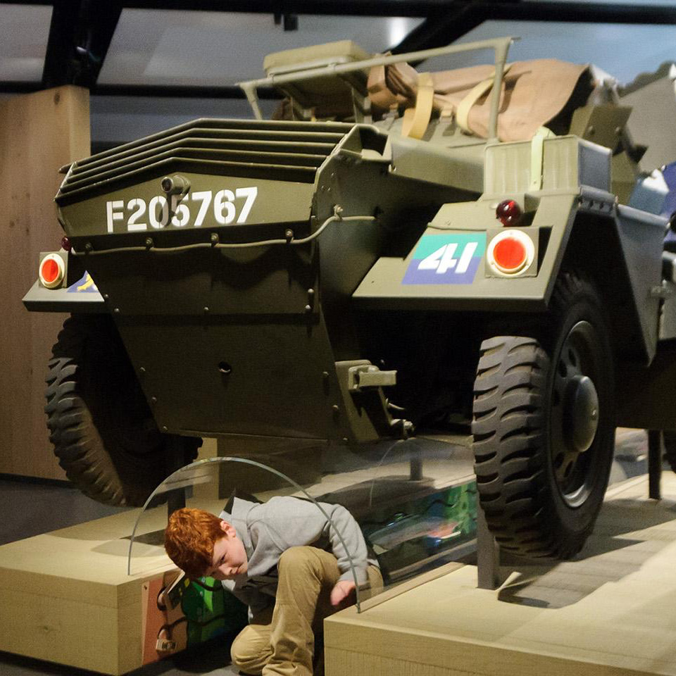 Child crawling under the Dingo Scout Car in the Soldier gallery