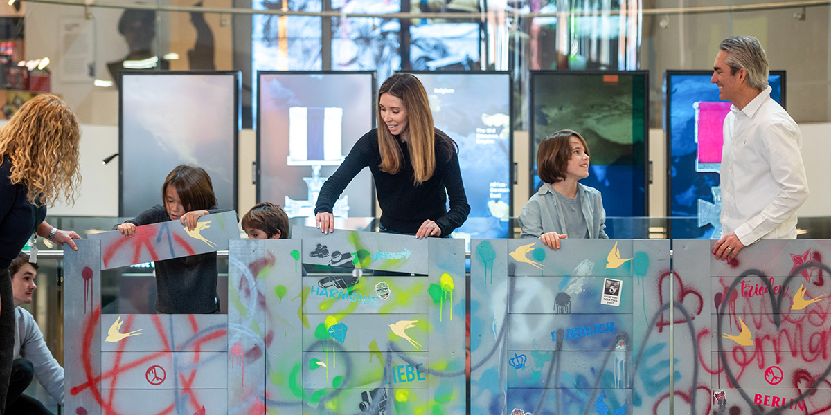 A family playing a game in the Atrium