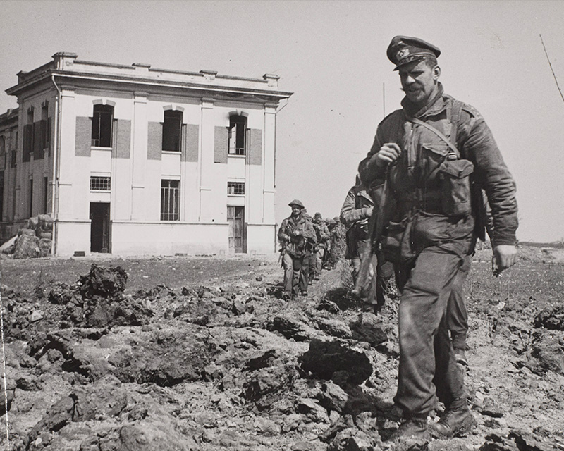 Men of 40 Royal Marine Commando leave a power plant they destroyed at Lake Comacchio, Italy, 11 April 1945