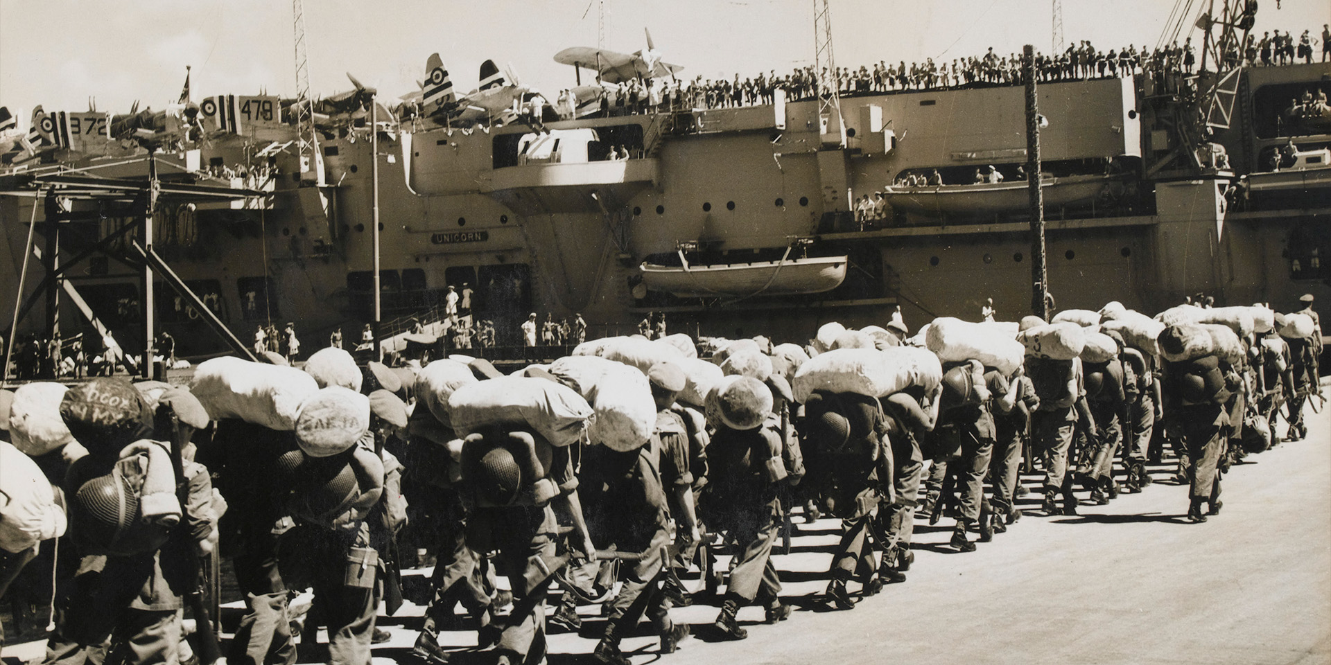 British troops board HMS Unicorn at Hong Kong for the voyage to Korea, 25 August 1950