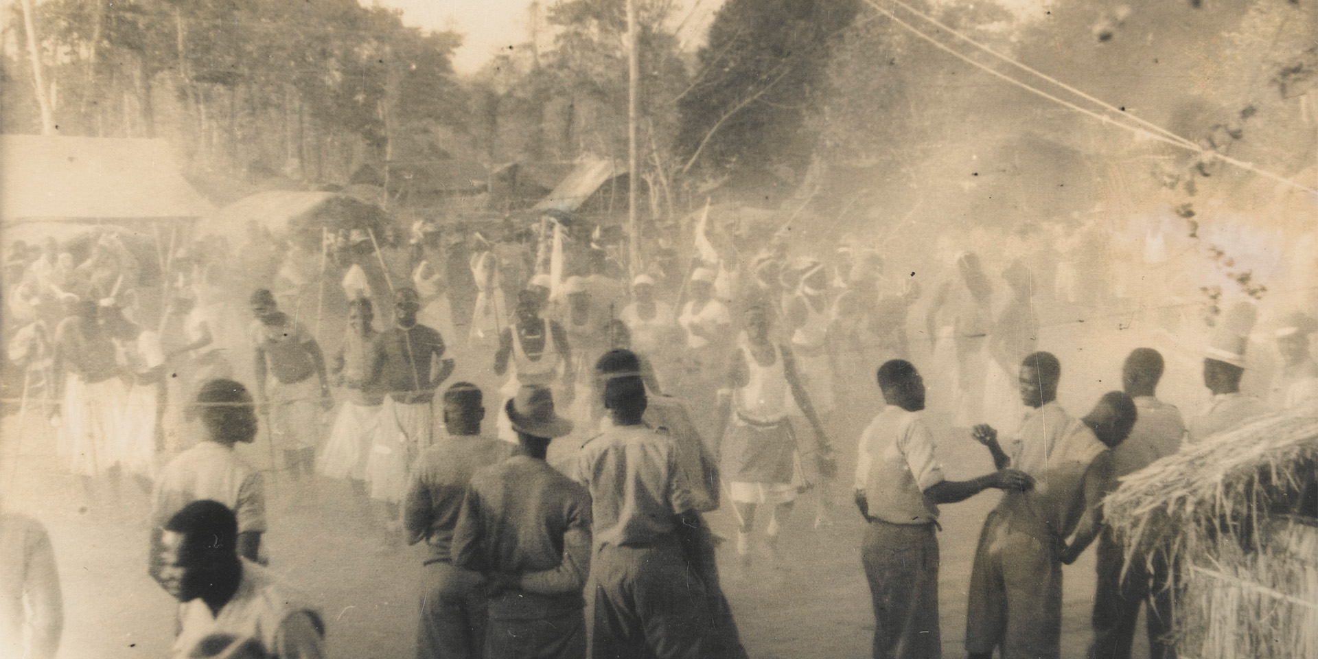 Soldiers of 4th (Uganda) Battalion, The King’s African Rifles, celebrate the end of the Second World War, 1945