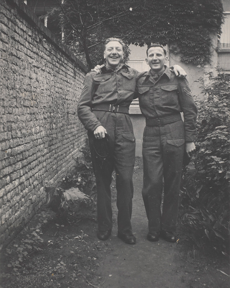 Sergeant J Ashley of the Royal Dragoons (left) celebrating victory with a friend, 1945