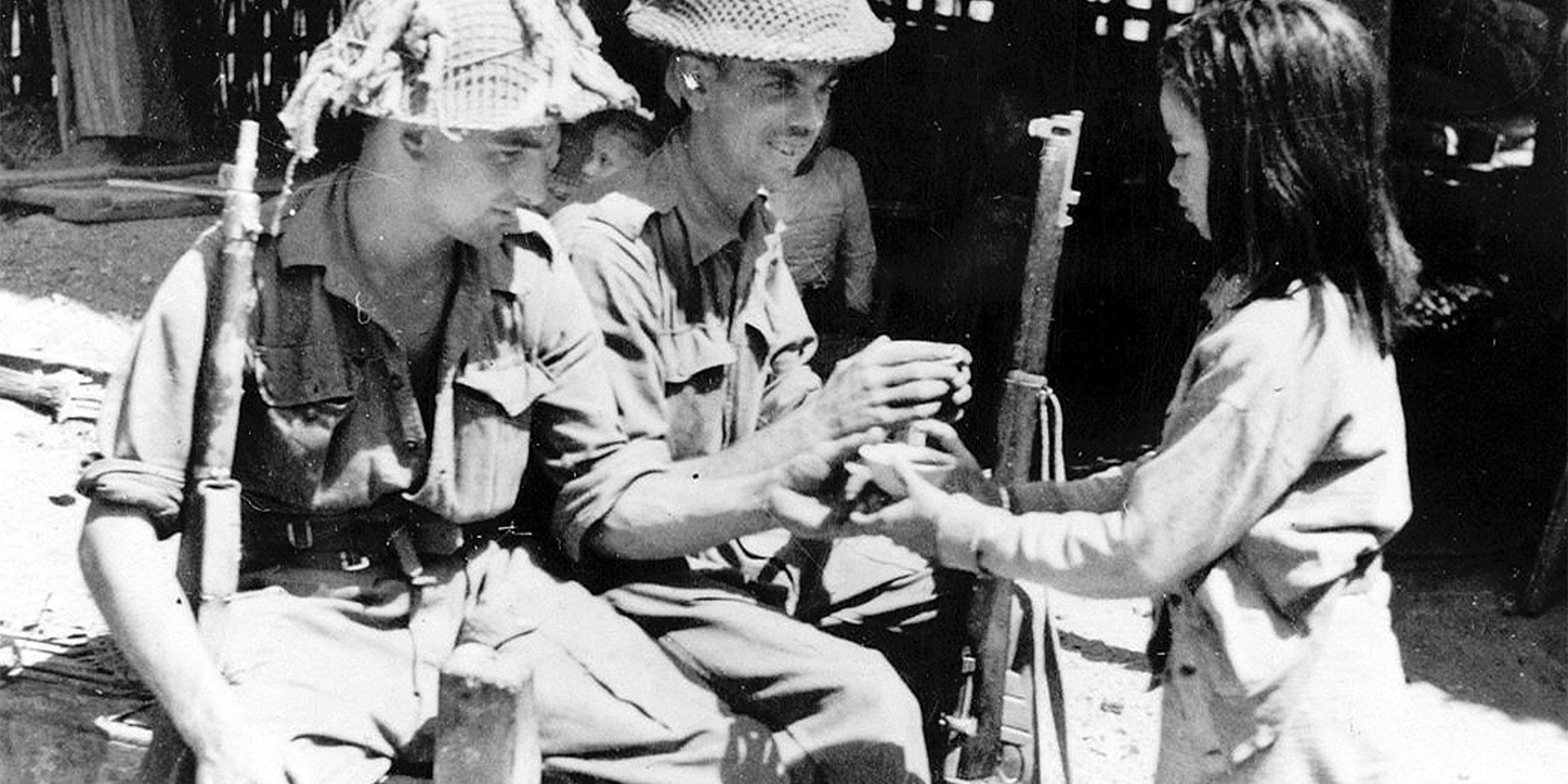Soldiers of 2nd Battalion, The Royal Berkshire Regiment, with a local girl in Burma, 1945