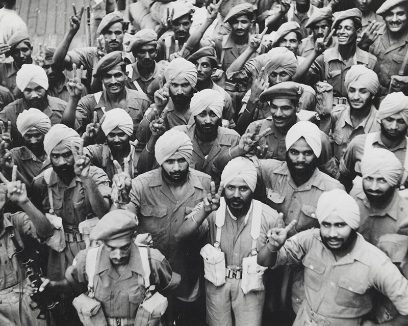 Indian soldiers giving the victory salute on their return to India after serving in Iran, 1946