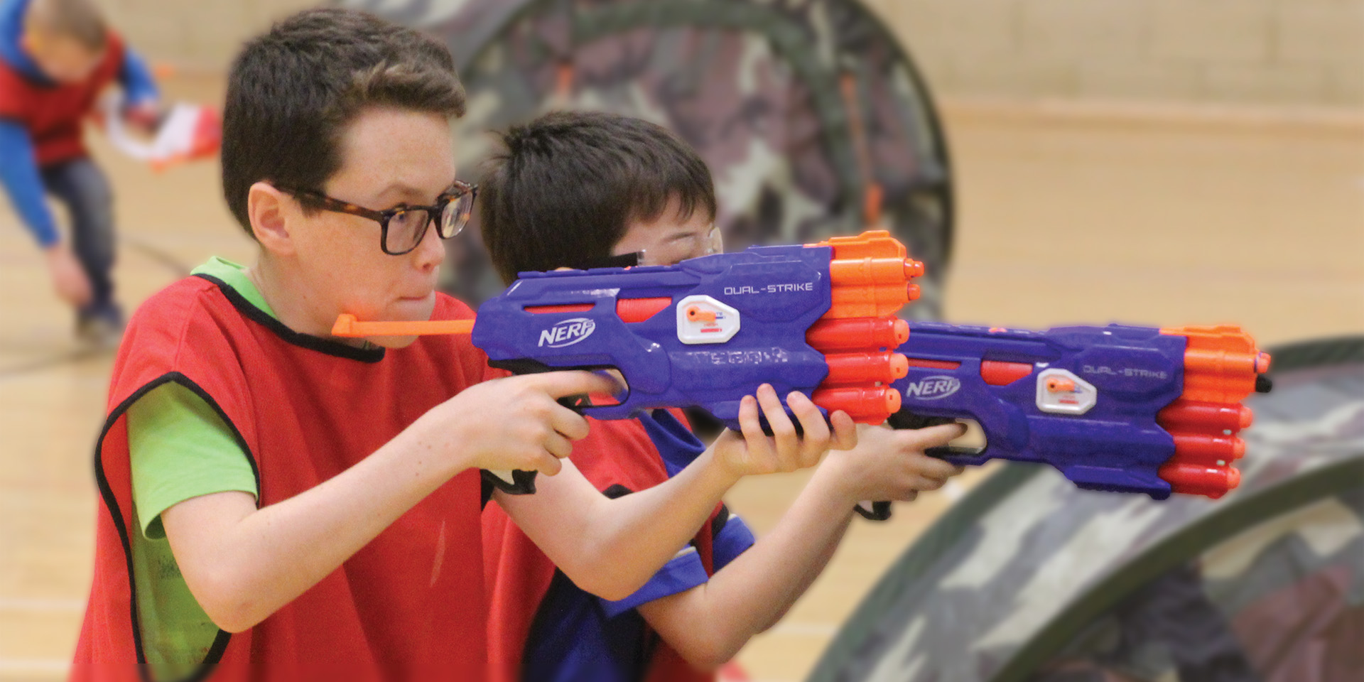 Children taking part in a Nerf gun battle