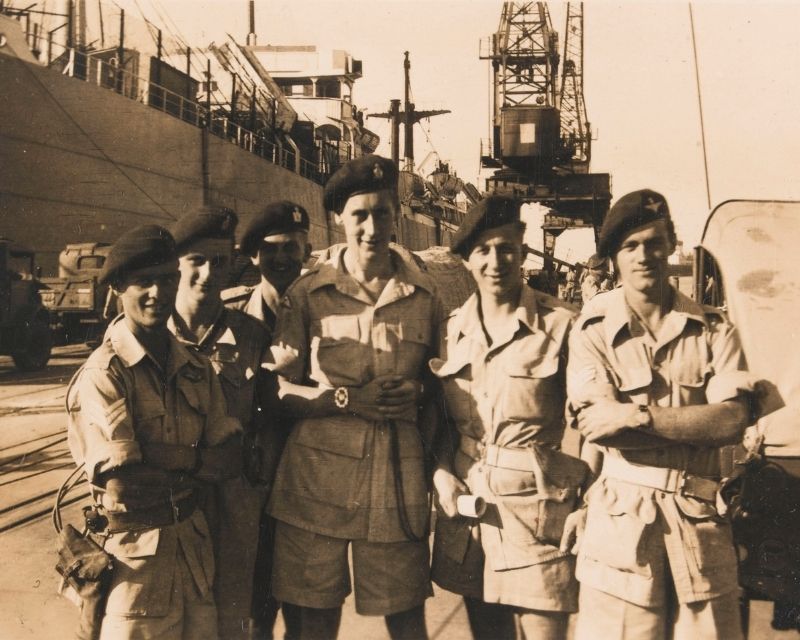 Members of 317 Airborne Field Security Section beside a docked ship at Haifa