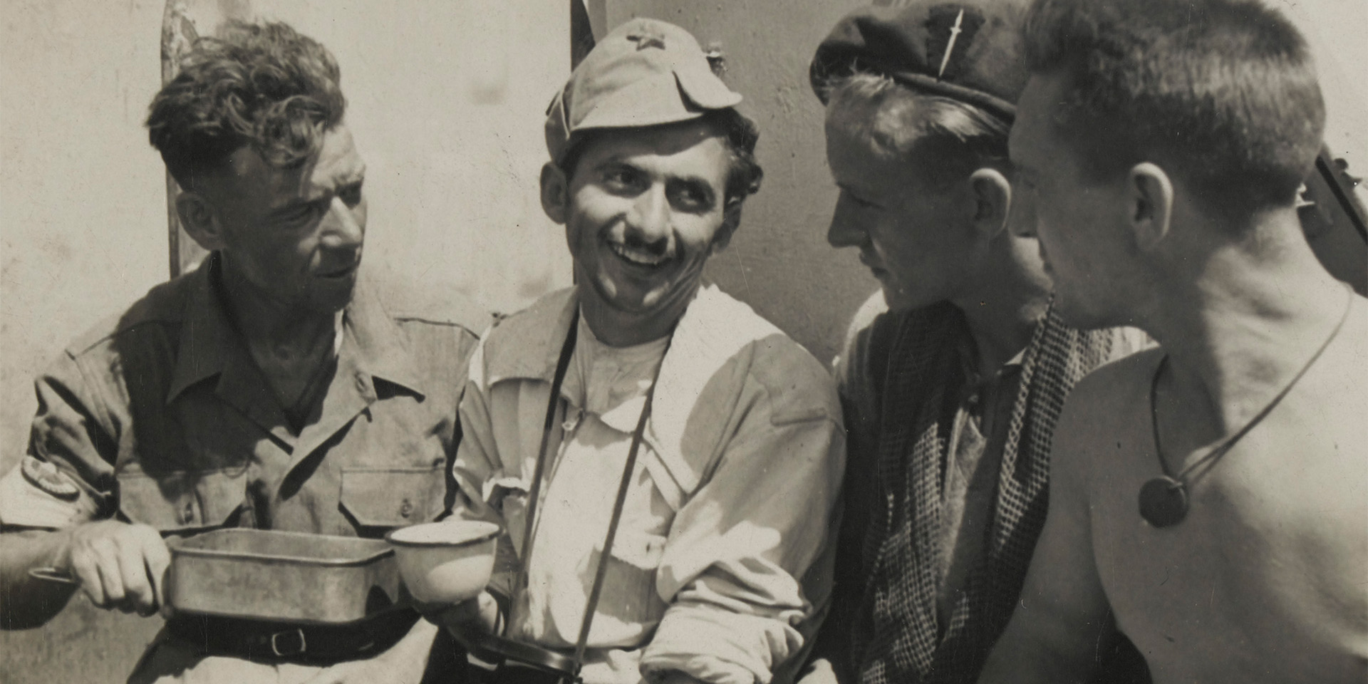 Men of No 2 Commando drinking tea with a Yugoslav partisan, 1944