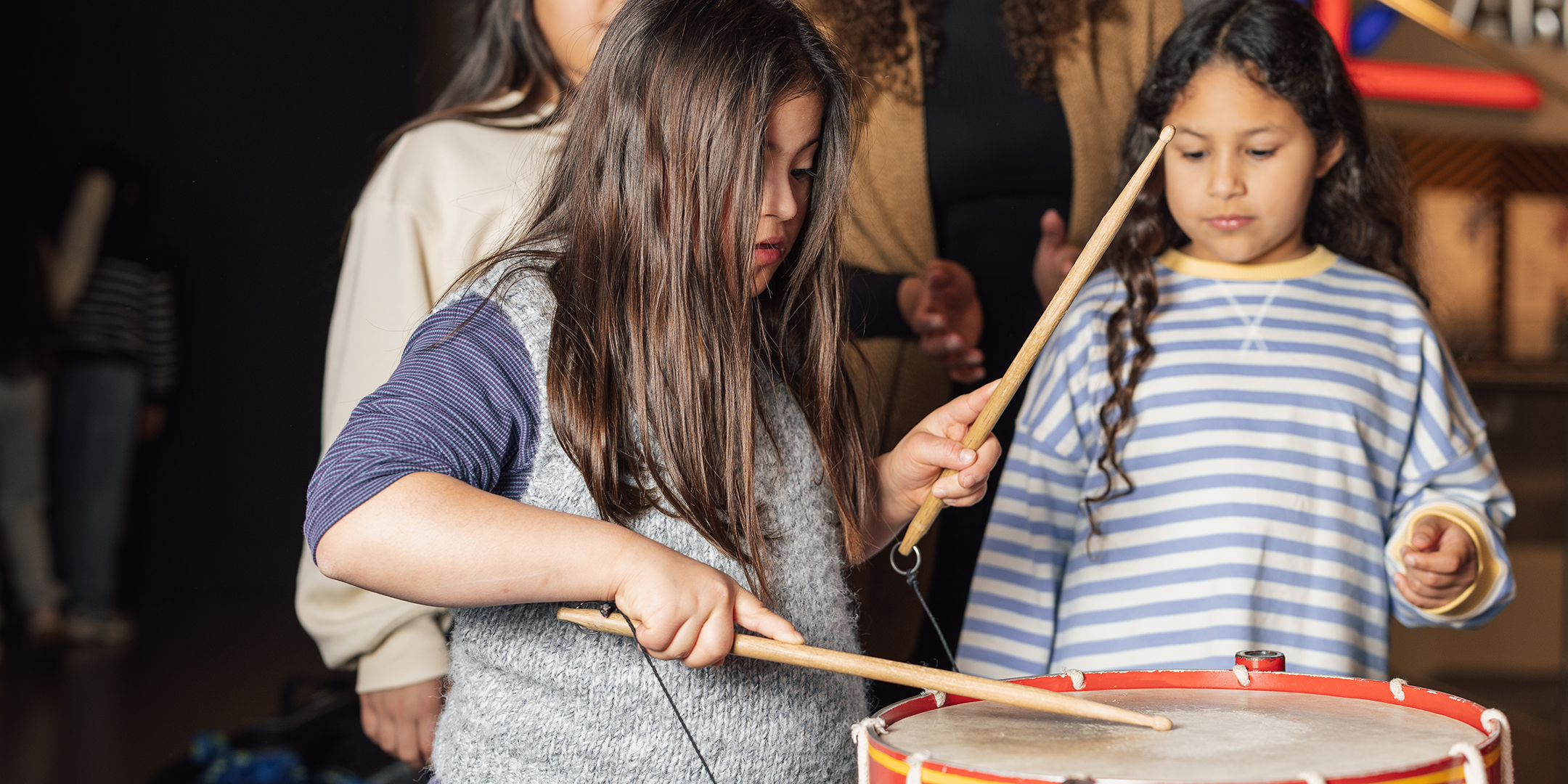 A family playing with the interactive battle drum