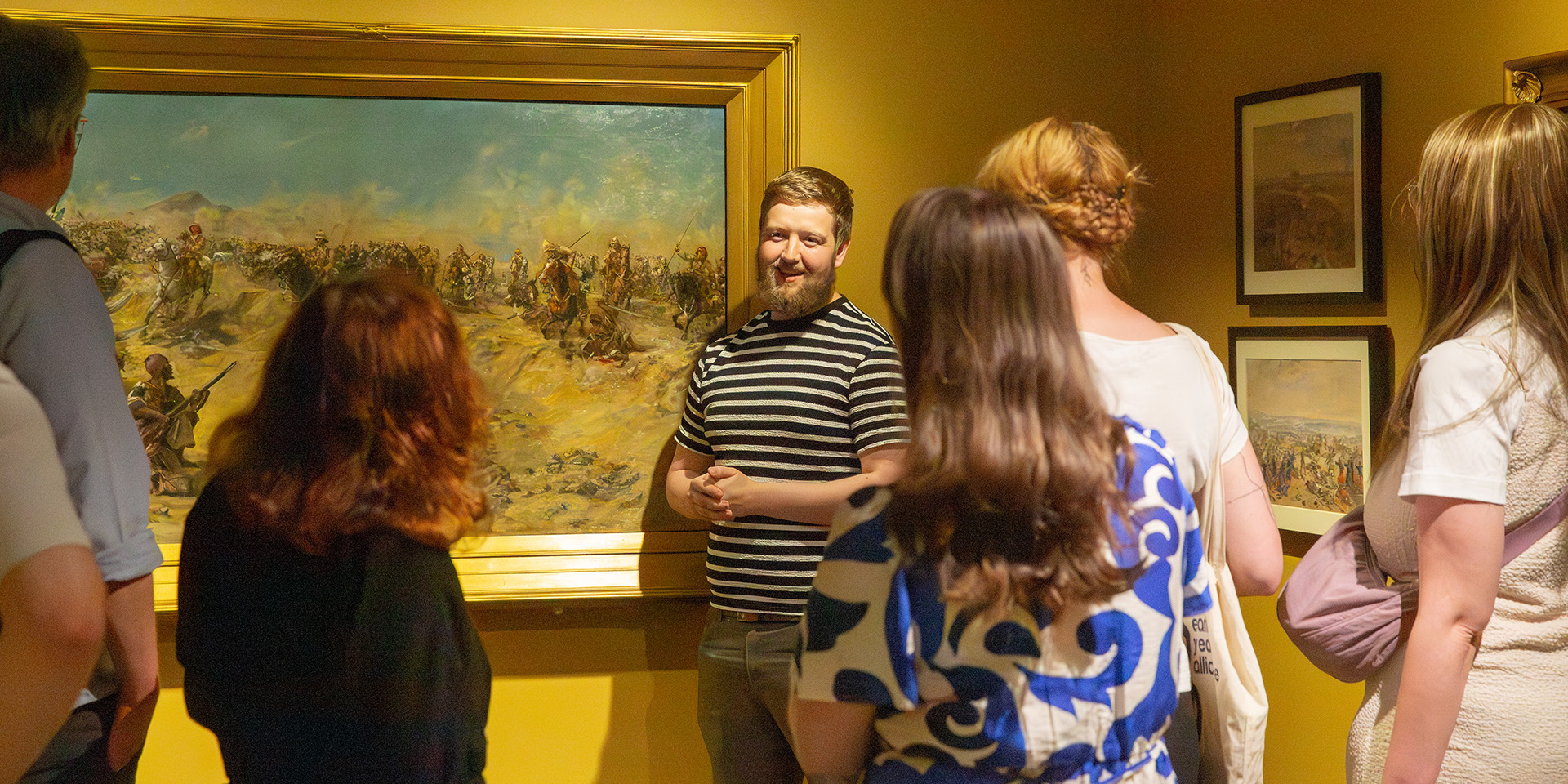 Visitors being led on a guided tour of the Myth and Reality exhibition